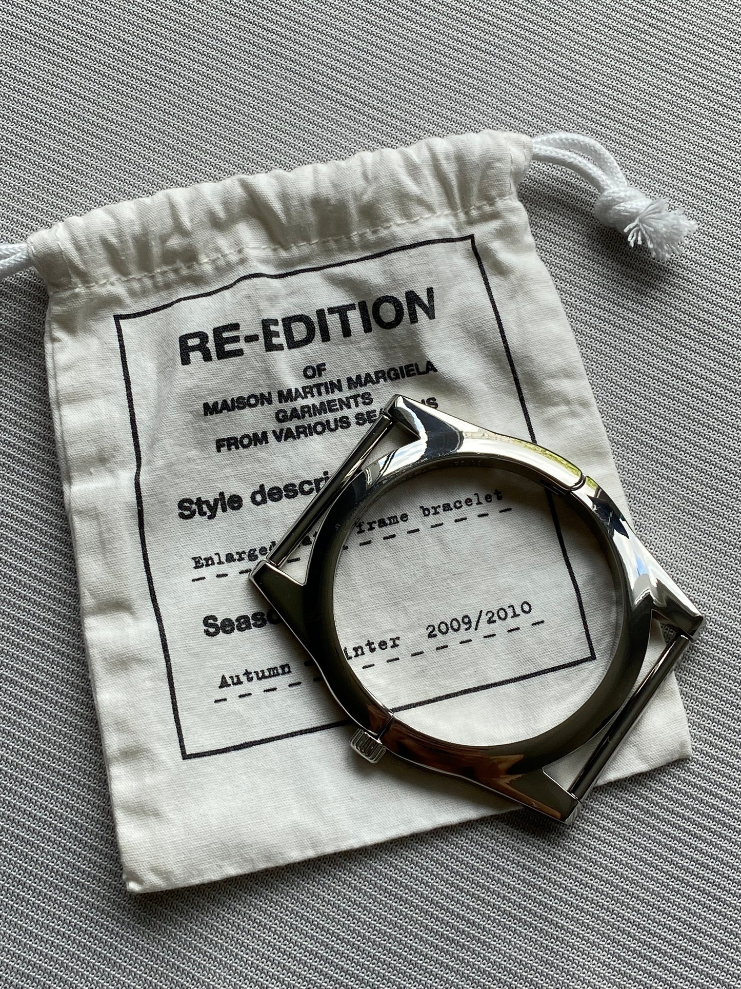 MAISON MARTIN MARGIELA X H&M ENLARGED WATCH FRAME BRACELET.