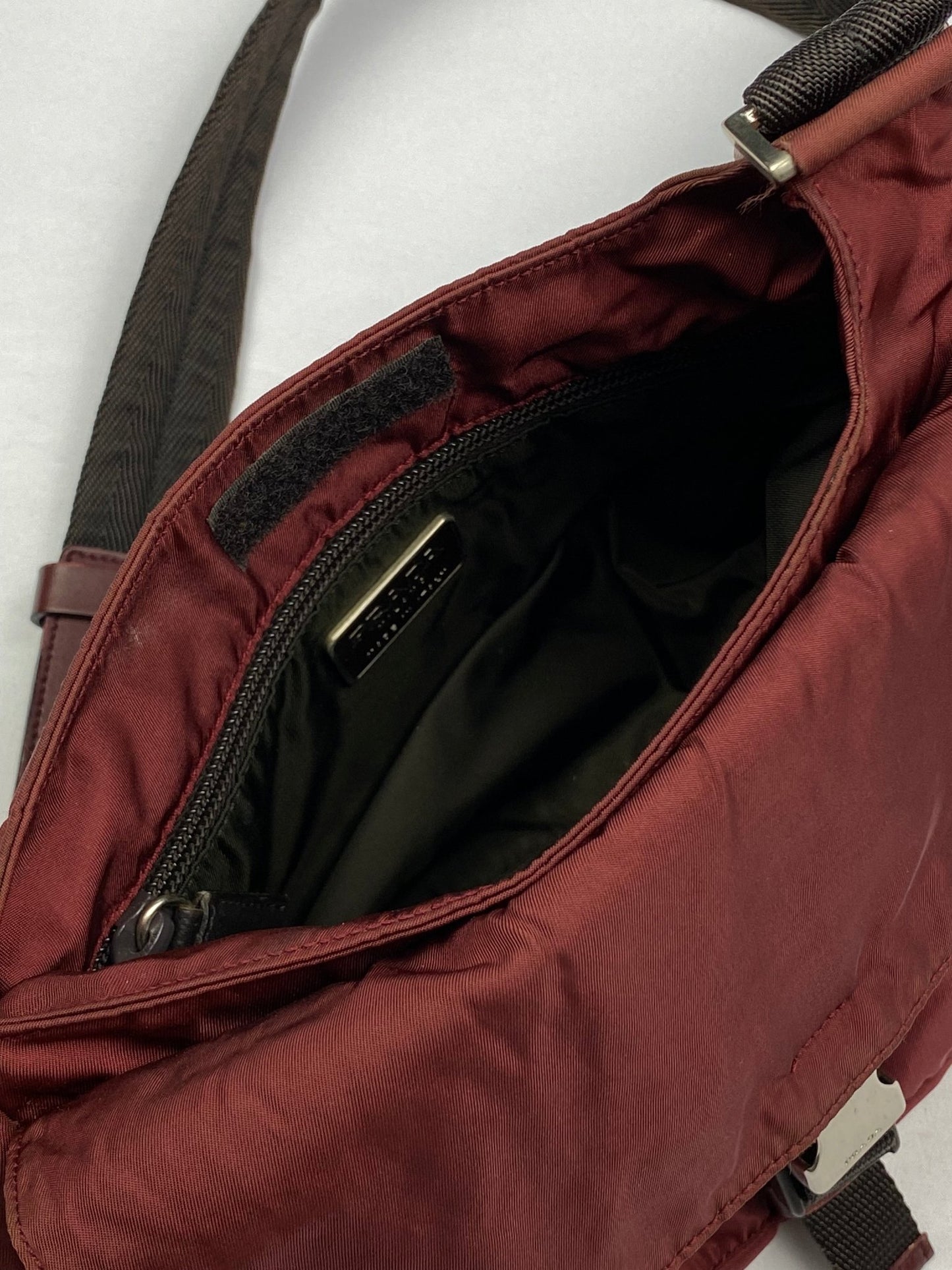 PRADA MILANO REVERSIBLE NYLON SLING BAG IN BURGUNDY. - SEVENUES.