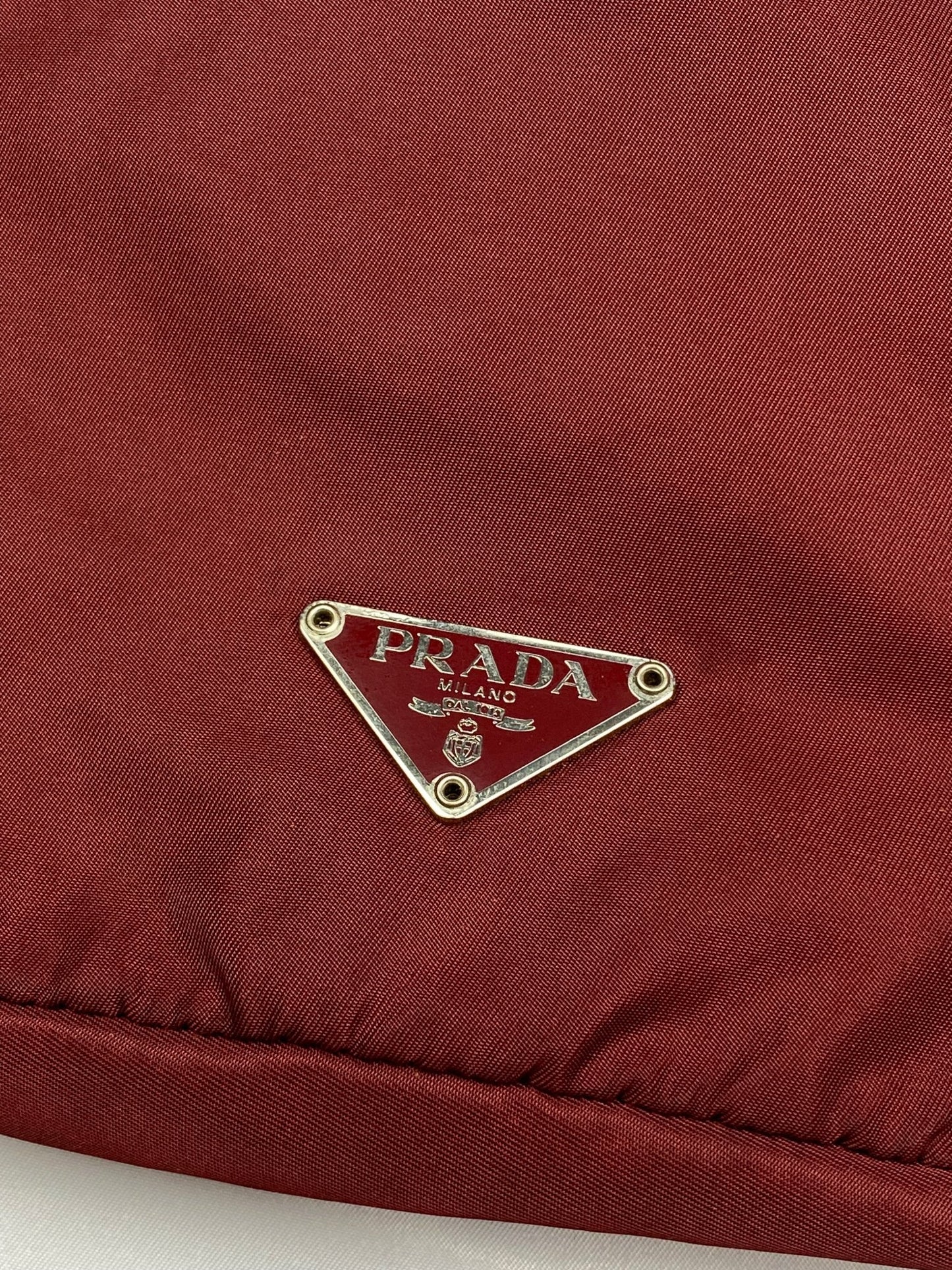 PRADA MILANO REVERSIBLE NYLON SLING BAG IN BURGUNDY. - SEVENUES.