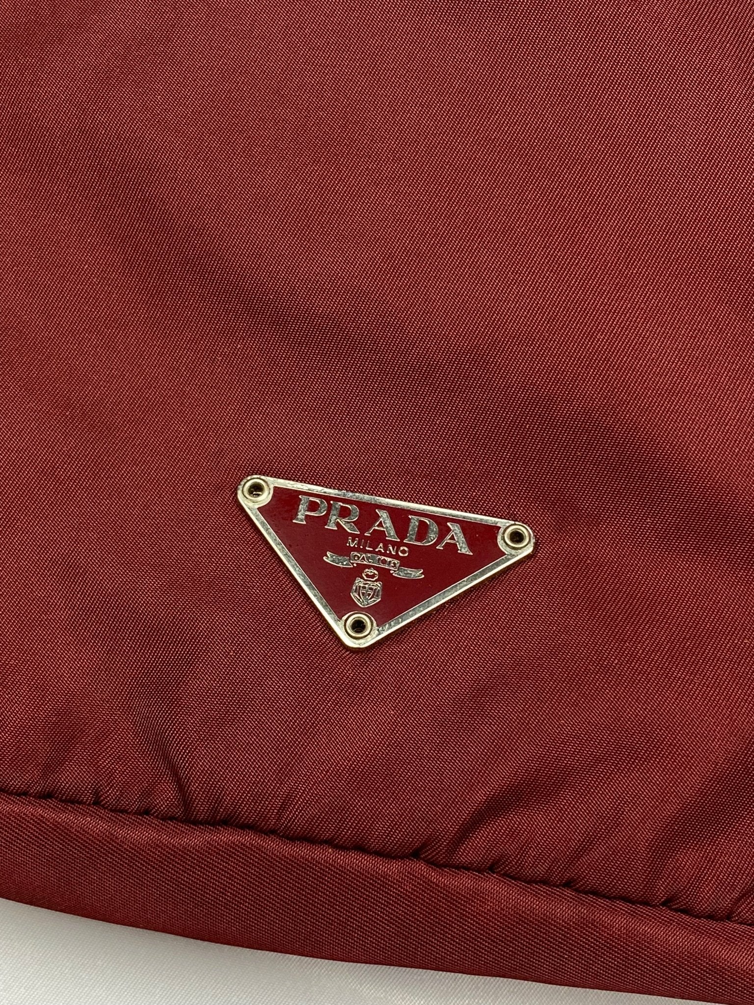 PRADA MILANO REVERSIBLE NYLON SLING BAG IN BURGUNDY. - SEVENUES.