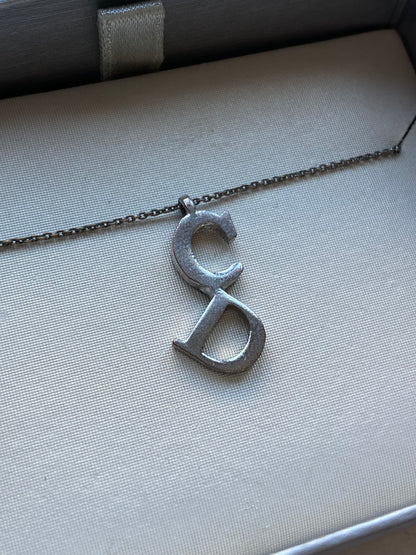 CHRISTIAN DIOR 'CD' SILVER PENDANT NECKLACE.