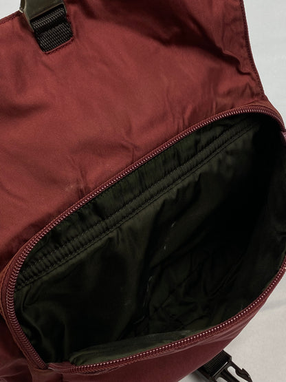 PRADA MILANO REVERSIBLE NYLON SLING BAG IN BURGUNDY.